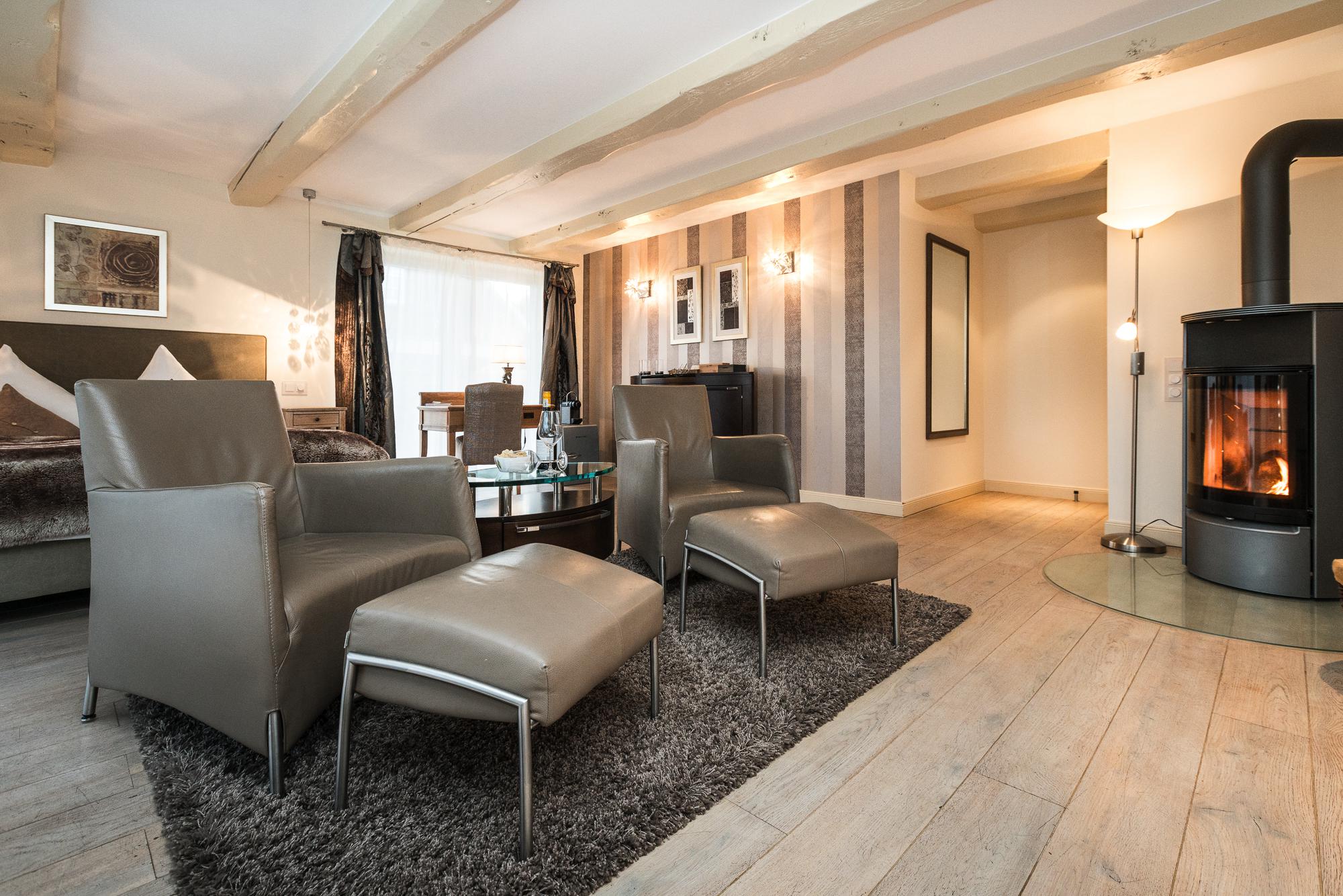 Sitzecke mit Kamin im Luxusdoppelzimmer im Hotel Landhaus Sylter Hahn in Westerland auf Sylt